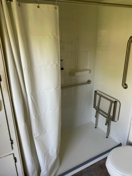 New Castle VA, Curbless shower, fold down shower bench, grab bars, handheld shower head